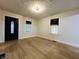 Open-concept living room featuring new wood flooring and lots of natural light at 946 N Somerset Ave, Indianapolis, IN 46222