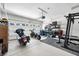 Spacious garage features two motorcycles, gym equipment, and overhead lighting with ample room for parking and storage at 963 Booneway Ln, Bargersville, IN 46106
