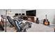 Cozy living room with modern entertainment setup, comfortable chairs, and personal touches create an inviting atmosphere at 963 Booneway Ln, Bargersville, IN 46106