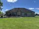 Expansive backyard featuring a stone patio, a built-in grill, and lush lawn, perfect for outdoor entertaining at 10 Sara Ct, Whiteland, IN 46184