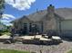 A brick patio in the backyard features a seating area and a lush lawn at 10 Sara Ct, Whiteland, IN 46184