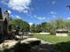 Landscaped backyard with an outdoor seating area and storage shed at 10 Sara Ct, Whiteland, IN 46184