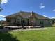 A large backyard featuring a stone patio with outdoor furniture and a lawn at 10 Sara Ct, Whiteland, IN 46184