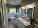 Elegant bathroom with a soaking tub, double vanity, and white cabinets at 10 Sara Ct, Whiteland, IN 46184