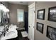 Bathroom featuring a dual sink vanity, decor, and a shuttered window for natural light at 10 Sara Ct, Whiteland, IN 46184
