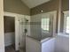 Modern bathroom featuring a glass-enclosed shower with white tiles, chrome fixtures, and natural light at 10 Sara Ct, Whiteland, IN 46184