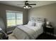 Cozy bedroom featuring a large window, ceiling fan, and comfortable bed with plush bedding at 10 Sara Ct, Whiteland, IN 46184
