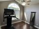 Home gym featuring a modern treadmill, mirror, and natural light from the arched window at 10 Sara Ct, Whiteland, IN 46184