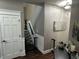 Cozy hallway featuring a staircase, white door, hardwood floors, and decorative wall art at 10 Sara Ct, Whiteland, IN 46184