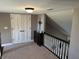 Hallway featuring a decorative wooden railing and upper-level closet at 10 Sara Ct, Whiteland, IN 46184
