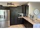 Well-equipped kitchen featuring stainless steel appliances, granite countertops, and dark wood cabinets at 10 Sara Ct, Whiteland, IN 46184