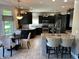 Modern kitchen with stainless appliances, dark cabinets, island, and breakfast nook with bay window at 10 Sara Ct, Whiteland, IN 46184