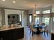 Open concept kitchen and dining area with breakfast bar, table, and bay window at 10 Sara Ct, Whiteland, IN 46184