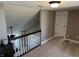 Open carpeted landing featuring a white spindle railing and access to other rooms at 10 Sara Ct, Whiteland, IN 46184