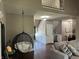Open-concept living room with a hanging chair, hardwood floors, and views of the staircase and entryway at 10 Sara Ct, Whiteland, IN 46184