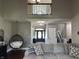 Bright, open living room with high ceilings, unique hanging chair, and cozy couch at 10 Sara Ct, Whiteland, IN 46184