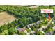 Aerial view of houses with pools near a nature trail entrance, surrounded by lush greenery at 10418 Forest Creek Dr, Indianapolis, IN 46239