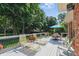 Inviting back deck featuring lounge seating and dining area with tree-lined backyard at 10418 Forest Creek Dr, Indianapolis, IN 46239