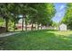 Large, grassy backyard with mature trees, a shed, and partial fencing for privacy at 10418 Forest Creek Dr, Indianapolis, IN 46239