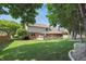 Expansive backyard with a deck, lush green lawn, mature trees, and a well-maintained exterior at 10418 Forest Creek Dr, Indianapolis, IN 46239