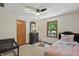Charming small bedroom featuring light walls, carpet, a ceiling fan, and a window with exterior views at 10418 Forest Creek Dr, Indianapolis, IN 46239
