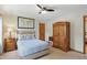 Cozy bedroom featuring carpet, an accent wall hanging, and light-colored walls to bring a sense of peace at 10418 Forest Creek Dr, Indianapolis, IN 46239