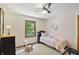 Cute small bedroom featuring light walls, carpet, a ceiling fan, and a window with exterior views at 10418 Forest Creek Dr, Indianapolis, IN 46239