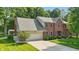 Charming two-story brick home with an attached two-car garage and a well-manicured lawn at 10418 Forest Creek Dr, Indianapolis, IN 46239