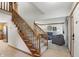Bright foyer with a wooden staircase, tiled floor, and a glimpse into the cozy living room at 10418 Forest Creek Dr, Indianapolis, IN 46239