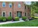 Welcoming front entrance with beautiful landscaping, black mulch, and a classic brick facade at 10418 Forest Creek Dr, Indianapolis, IN 46239