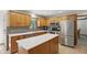 Spacious kitchen with stainless steel appliances, an island, and tile backsplash at 10418 Forest Creek Dr, Indianapolis, IN 46239