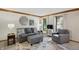 Comfortable living room with a gray sofa, accent chairs, and natural light from the windows at 10418 Forest Creek Dr, Indianapolis, IN 46239
