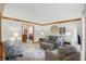 Cozy living room with comfortable seating, a neutral color palette, and an open doorway to the dining room at 10418 Forest Creek Dr, Indianapolis, IN 46239