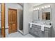 Main bathroom features a walk-in shower with glass door and gray vanity with double sinks at 10418 Forest Creek Dr, Indianapolis, IN 46239