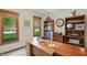 Inviting home office with a wooden desk, bookcase, and a large window overlooking the landscaped yard at 10418 Forest Creek Dr, Indianapolis, IN 46239