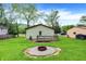 A spacious backyard features a fire pit area and a wood deck at the back of the home at 10972 W Old Nashville Rd, Columbus, IN 47201