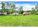 A generous backyard featuring a deck, outbuilding, and ample green space at 10972 W Old Nashville Rd, Columbus, IN 47201
