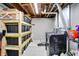 Unfinished basement laundry and storage area with black storage containers and black appliances at 10972 W Old Nashville Rd, Columbus, IN 47201