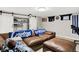 Finished basement featuring a comfortable brown leather couch and a barn door closet at 10972 W Old Nashville Rd, Columbus, IN 47201