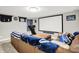 Finished basement features a home theater setup with a large screen and comfortable seating at 10972 W Old Nashville Rd, Columbus, IN 47201