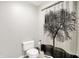 The bathroom boasts a toilet and decorative shower curtain showcasing a prominent tree design at 10972 W Old Nashville Rd, Columbus, IN 47201