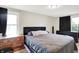 Bedroom with a cozy bed, dressers, and natural light from two windows, perfect for relaxation at 10972 W Old Nashville Rd, Columbus, IN 47201