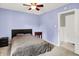 Cozy bedroom with carpet floors and a ceiling fan, featuring an elegant vintage bedside table at 10972 W Old Nashville Rd, Columbus, IN 47201
