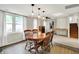 Dining area with stairs, fireplace, and an elegant lighting fixture, creating a warm atmosphere at 10972 W Old Nashville Rd, Columbus, IN 47201
