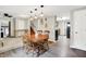 Open dining room area seamlessly leading to kitchen and living spaces, featuring wood flooring at 10972 W Old Nashville Rd, Columbus, IN 47201