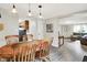Dining area with wooden table, seamlessly connecting to kitchen and living room, enhancing the open-concept layout at 10972 W Old Nashville Rd, Columbus, IN 47201