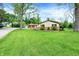 This home features stone accents and lush front yard landscaping at 10972 W Old Nashville Rd, Columbus, IN 47201