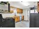 Well-lit kitchen features stainless steel appliances, wood cabinets, modern fixtures, and a rear access door at 10972 W Old Nashville Rd, Columbus, IN 47201