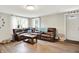 Comfortable living room featuring a large sectional couch, wood floors, and bright lighting at 10972 W Old Nashville Rd, Columbus, IN 47201