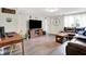 Living room with a spacious seating area, wood floors, a TV, and a rustic decor at 10972 W Old Nashville Rd, Columbus, IN 47201